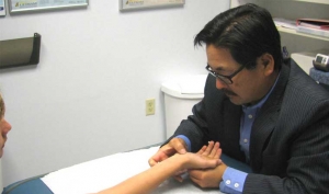 dr_choi_evaluating_patient_wrist